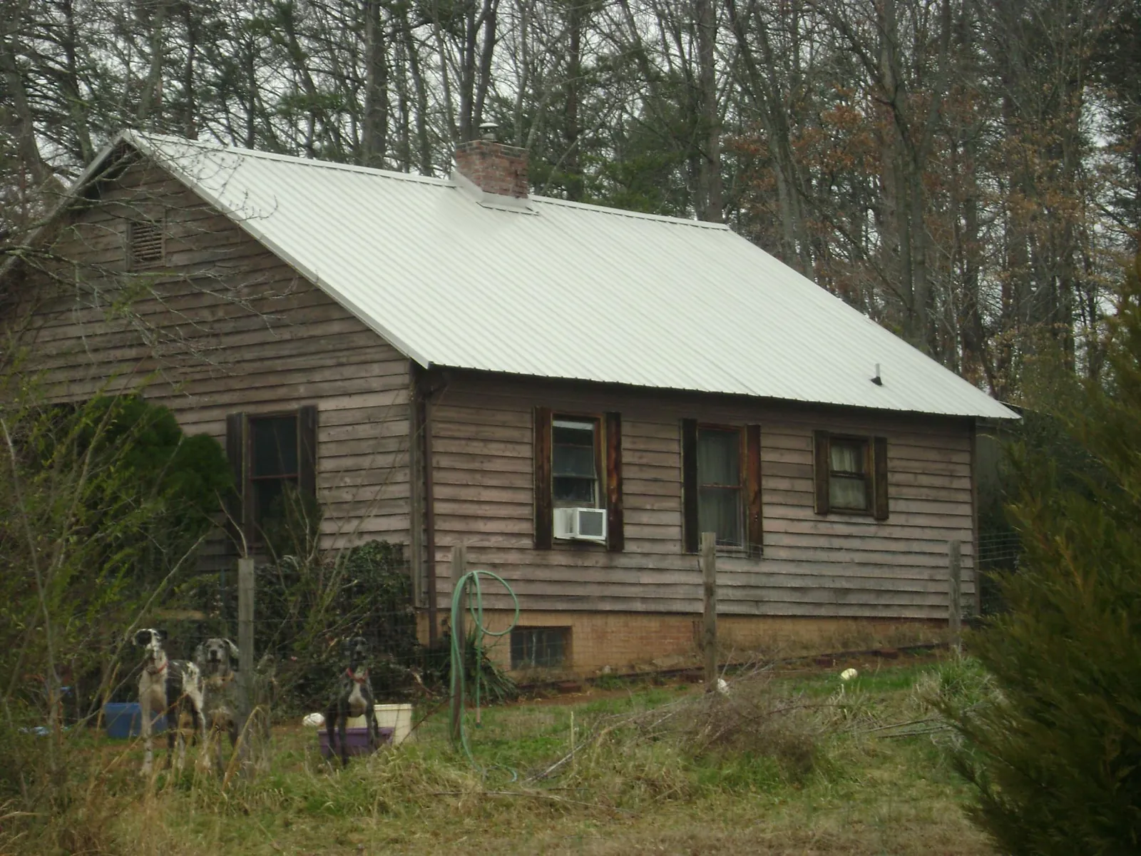 White metal roof on an old wood sided farmhouse, from a Metal Roof Installation job in Coward